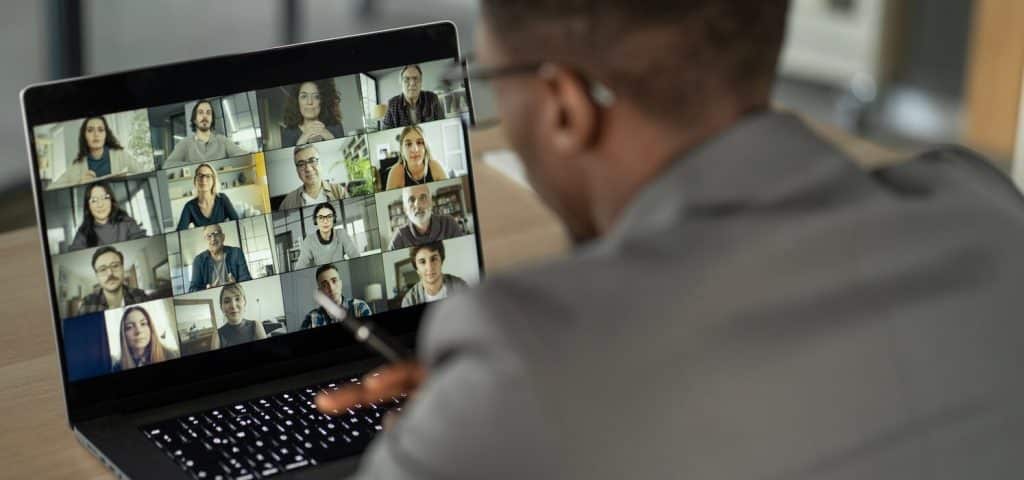 Man with laptop taking online class, online learning